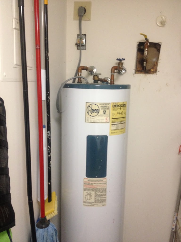 Original Water Heating Experts field photograph of a vintage Rheem water heater documented as dating to 1984