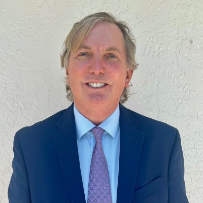 Eric Strand, founder of Water Heating Experts, wearing a blue suit