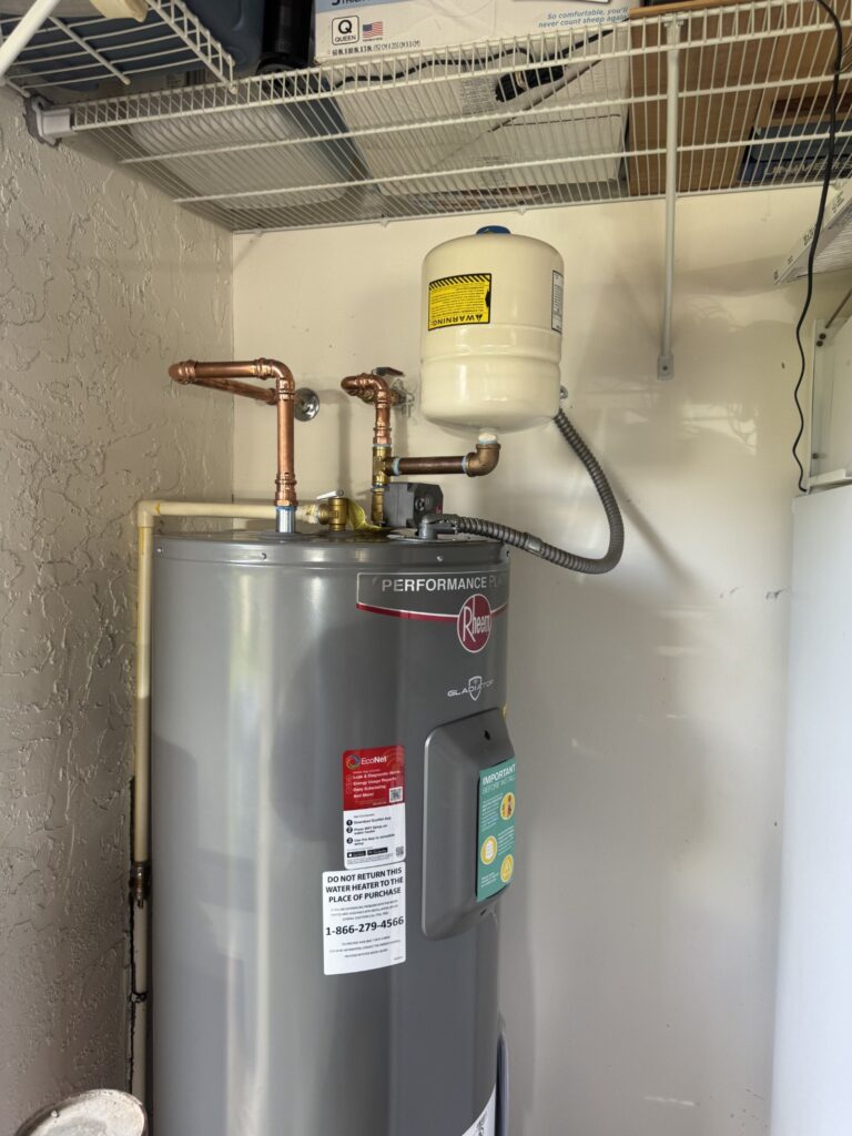 Rheem Gladiator electric water heater installed by Water Heating Experts in Royal Palm Beach with copper piping and an expansion tank
