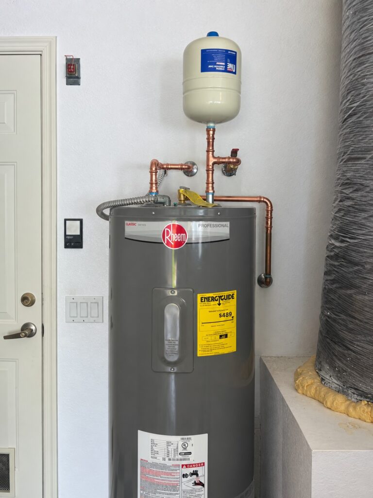 Rheem Professional electric water heater installed by WHE in the Loxahatchee area with copper piping and an expansion tank