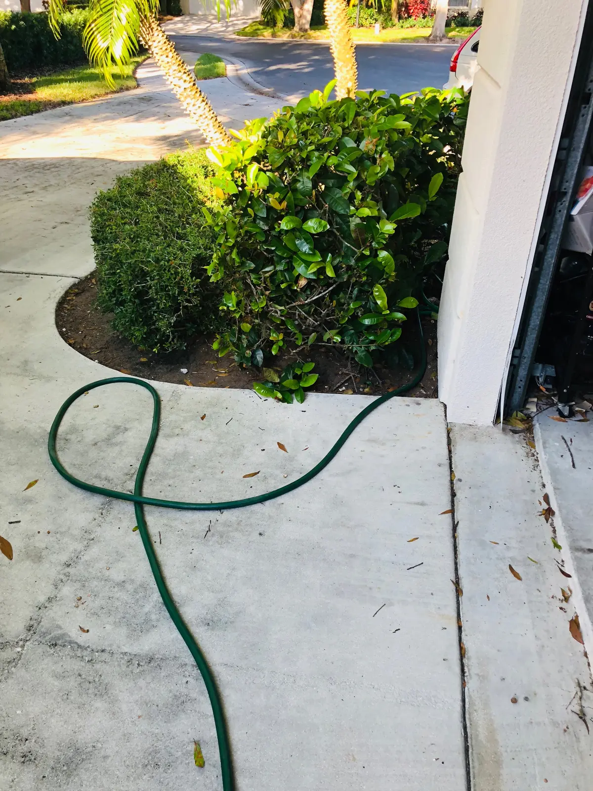 Water Heating Experts job-site photo showing a hose used to drain a water heater